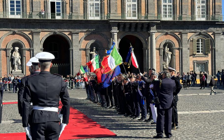 Military members who served their country dressed in uniform proudly wave their flags 